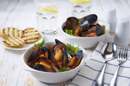 Photo for Mussels with tomato sauce close-up. Seafood background photo. - Royalty Free Image