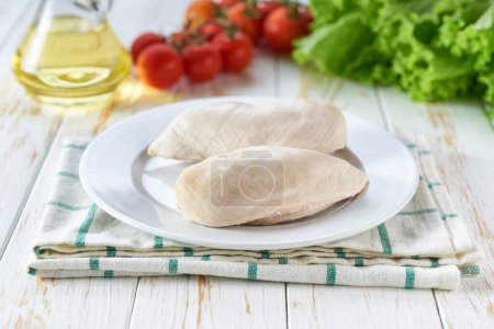 Photo for Boiled chicken breast with herbs, olive oil and pepper, selective focus. Culinary ingredients for cooking. - Royalty Free Image