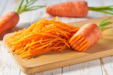 Photo for Fresh grated carrots on a cutting board, selective focus. - Royalty Free Image