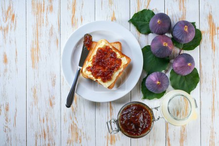 Photo for Plate with toast and sweet figs jam on light wooden table, top view - Royalty Free Image