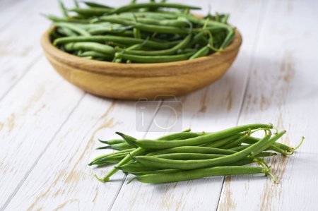 Photo for Organic green beans in a bowl on a wooden table, rustic style. - Royalty Free Image