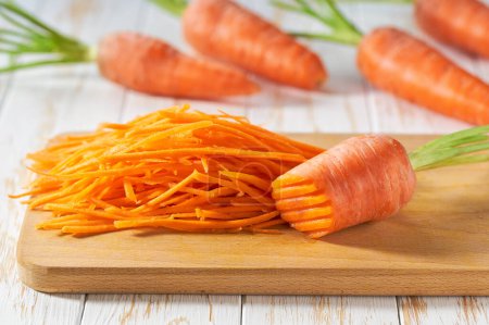 Photo for Grated organic carrots on a cutting board,  selective focus. - Royalty Free Image