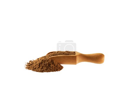 Photo for Cinnamon powder poured out from a wooden spoon isolated on a white background. - Royalty Free Image