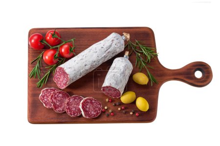 Photo for Traditional Spanish fuet spicy pork dry cured salami sausages with rosemary and olives on a wooden cutting board isolated. - Royalty Free Image