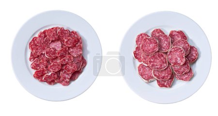 Photo for Spicy pork fermented dry cured salami sausages cut in slices on a white ceramic plate, isolated on a white background, top view. - Royalty Free Image
