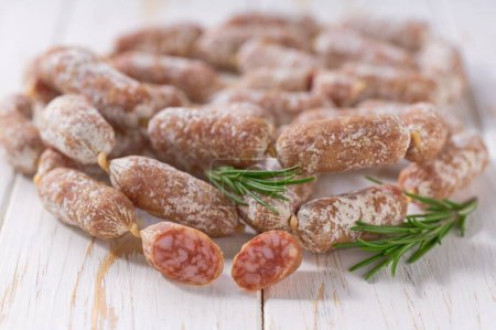 Photo for Chorizo mini, spicy pork fermented dry cured salami sausages close up on a wooden table. - Royalty Free Image