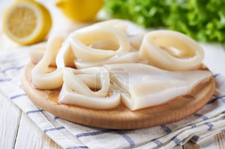 Photo for Preparation of raw squid and ingredients on the table close-up. - Royalty Free Image