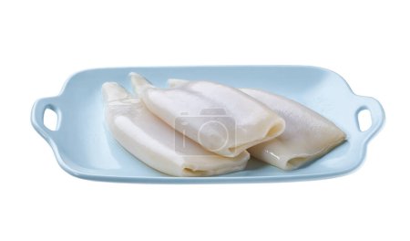 Photo for Fresh raw squid or cuttlefish fillet in a blue plate isolated on a white background. - Royalty Free Image