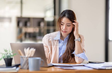 Young business Asian women are stressed while working on laptop, Tired asian businesswoman with headache at office, feeling sick at work copy space in workplace an home office.
