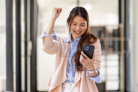 Photo for Happy excited.Portrait of success business asian woman enjoy success with laptop on work desk. Authentic shot joyful asian girl got jackpot, Surprised and celebrating her victory. - Royalty Free Image