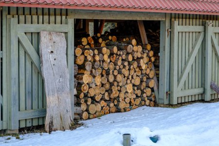 Photo for Large modern wood plank shed for firewood storage with dry firewood - Royalty Free Image