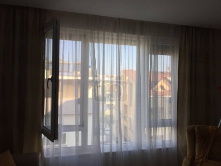 Photo for Open window with tulle curtains - Royalty Free Image