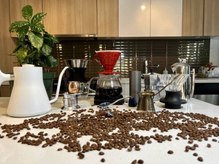 Photo for Different professional coffee equipment on the table next to the coffee flower as well as different accessories for brewing coffee Craft ad In foreground beans are scattered on the table - Royalty Free Image