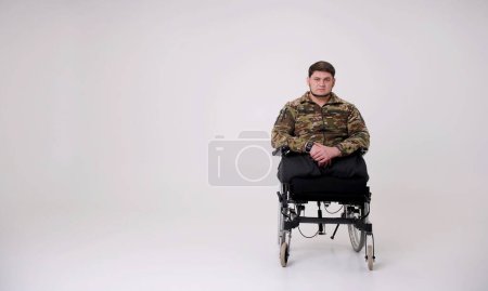 man in camouflage uniform soldier sitting in wheelchair and smiling at camera having rehabilitation at clinic for injured veterans panorama with copy space Russia attacked Ukraine