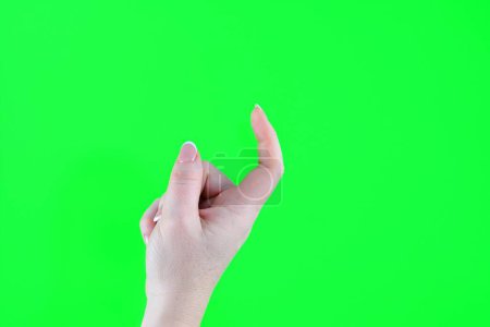 Photo for Beckon with a finger female index finger crooked reckoning come over here isolated on green background. High quality photo - Royalty Free Image