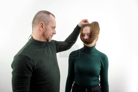 Photo for Comic photo of man winding hair on girls face misbehavior of children and adults relations in family domineering father husband search for image Beauty requires sacrifice on white background design - Royalty Free Image