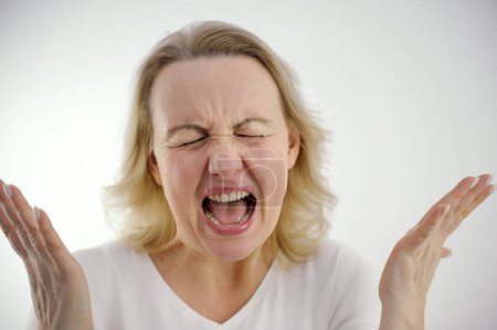 Screaming loudly dissatisfied woman sad angry spread arms to sides spread fingers pinched eyes screaming hysteria nerves psychological help nervousness antidepressants studio on white background