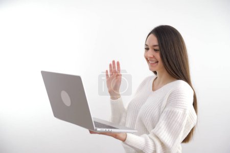 Photo of joyful happy positive mature woman wave hello computer online meeting indoors inside house home. High quality photo
