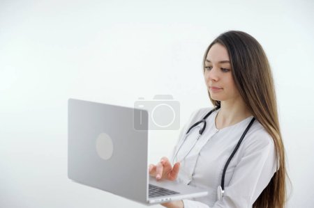 Photo for Shoulder view young woman consulting with family therapist doctor general practitioner online via video call on laptop after feeling first virus illness symptoms, medical insurance - Royalty Free Image