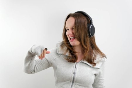 Photo for Beautiful Lady Listening and Singing to Music. High quality photo - Royalty Free Image