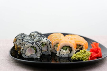 Photo for Set Philadelphia and California oriental cuisine japanese food vegetarians adore on a beautiful dark background sushi bar outrageous rolls appetizing fish and rice wrapped in nura on atmospheric - Royalty Free Image