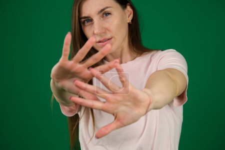 Beautiful young woman wearing casual t-shirt over isolated background Rejection expression crossing arms and palms doing negative sign, angry face