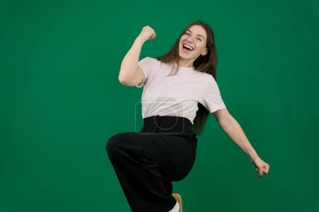 Astonished champion triumphant lady celebrate victory isolated on color background