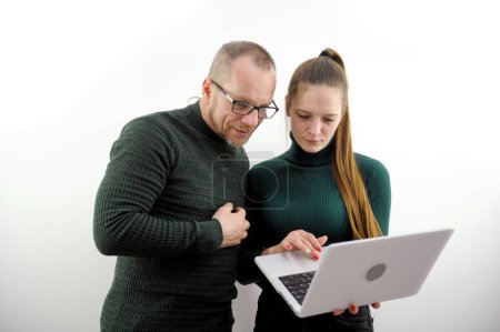 Male professional mentor helping female client teach intern training new worker consult customer explain online business services computer corporate software Man and woman working on laptop computers