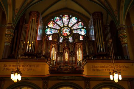 Photo for Decorative pipe organ in the loft of a gothic Catholic Cathedral - Royalty Free Image