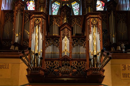 Photo for Decorative pipe organ in the loft of a gothic Catholic Cathedral - Royalty Free Image