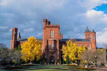 Photo for Washington D. C.  United States. November 30, 2022: Smithsonian Institution (Smithsonian Castle) and autumn trees. - Royalty Free Image