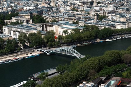 Photo for Paris, France. April 22, 2022: Debilly footbridge with Paris bridge and Seine river. - Royalty Free Image