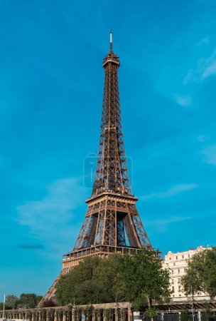 Photo for Paris, France. April 22, 2022: Landscape with a view of the Eiffel Tower and beautiful blue summer sky. - Royalty Free Image