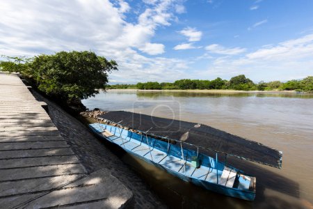 Photo for Panoramic landscape with blue boat on the bank of the Magdalena river. Neiva, Colombia. - Royalty Free Image