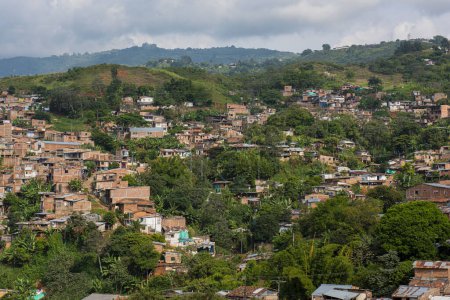 Téléchargez les photos : Cali, Valle del Cauca, Colombie. 17 mai 2018 : Cabine bleue du système de transport MIO et maisons aux façades colorées. - en image libre de droit