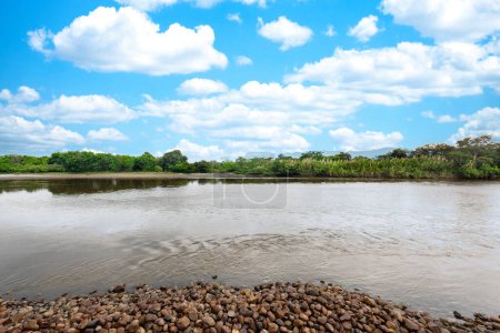 Neiva, Huila, Colombia. May 2019: Panoramic landscape with blue boat on the bank of the Magdalena river.