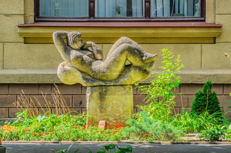 sculpture of a reclining woman, in the garden, modern sculpture decorated in antique style. Kharkiv Ukraine 05-05-2023