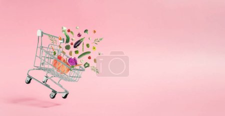 Photo for Various colorful vegetables coming out of shopping cart. Spring nature concept. Season background idea. Creative abstract concept. Pop art aesthetic with copy space for text. - Royalty Free Image