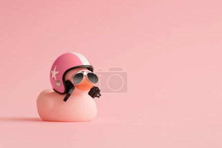 Photo for Creative composition made of pink cute little rubber duckling with a helmet and sunglasses on pink background.Summer minimal duck concept. Creative art, Contemporary style.Writing space, copy space. - Royalty Free Image