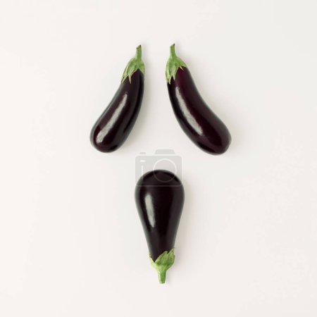 Photo for Ghost face made with eggplants against white background. Creative Halloween concept. Minimal Spooky Holiday season concept, trendy background Creative art and minimal aesthetics - Royalty Free Image