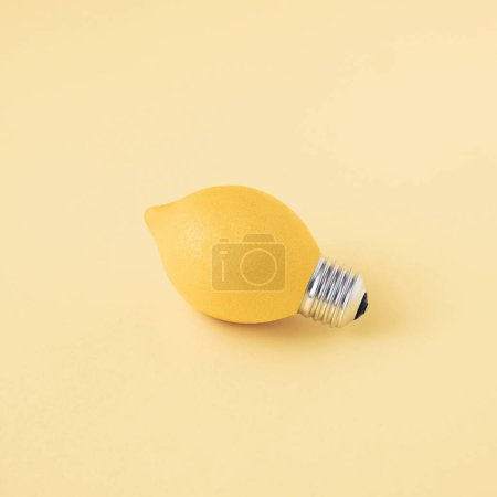 Photo for A single fresh lemon as a light bulb isolated on a bright yellow background. Trendy fruit idea. Abstract and surreal healthy diet. Creative food concept. - Royalty Free Image