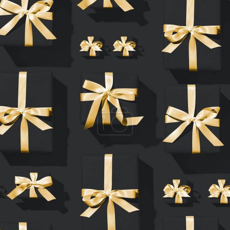 Photo for Minimal composition of dark black background and gold bows Christmas gift box. New Year concept. - Royalty Free Image