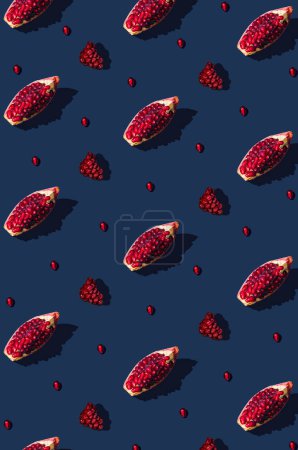Photo for Creative pattern made of fresh slices of pomegranate on blue background with sharp shadows. Minimal concept . Top view. Trendy social mockup.Flat lay - Royalty Free Image