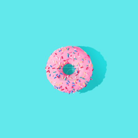 Photo for Pink glazed donut on blue pastel background. Flat lay. Creative concept. - Royalty Free Image