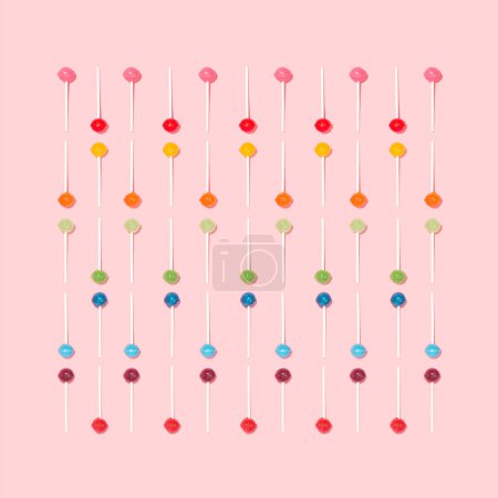 Photo for Colorful pattern made of lollipops on a pastel pink background. Flat lai. The concept of sweets. - Royalty Free Image