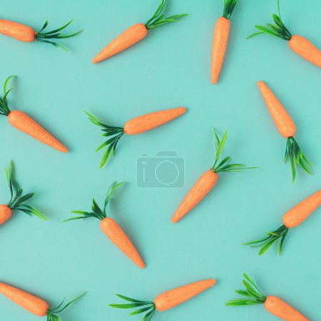 Photo for Easter pattern made with carrots on bright blue background.Creative Easter holiday concept. Minimal spring holiday celebration greeting card or idea. Flat lay. - Royalty Free Image