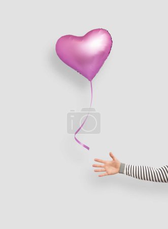 Photo for Heart shaped balloon floating away - Royalty Free Image