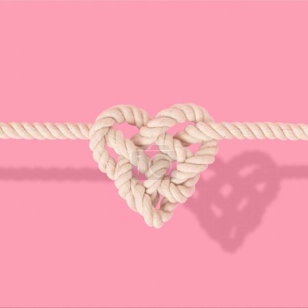 Foto de Cuerda en forma de corazón nudo sobre fondo rosa - Imagen libre de derechos