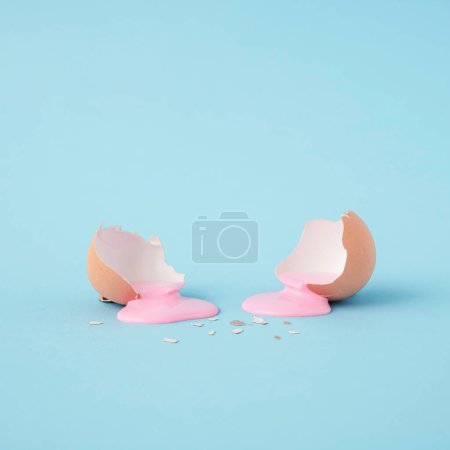 Photo for Modern Abstract easter composition with Eggshell ,pastel pink paint.and copy space on pastel blue background. Minimal Easter holiday concept. Creative art minimal aesthetics. - Royalty Free Image
