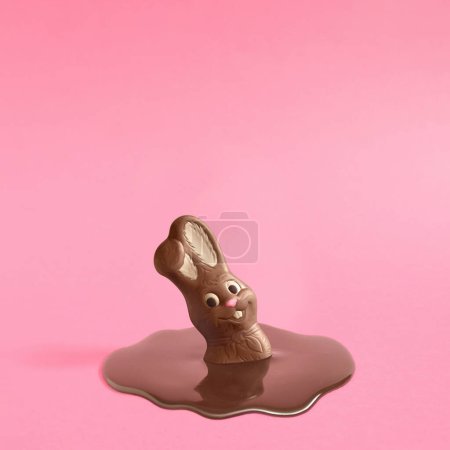 Photo for Trendy composition with Easter chocolate bunny rabbit melting on pink pastel background .Creative art, minimal aesthetic look. Contemporary style.Writing space, copy space, minimal easter concept - Royalty Free Image